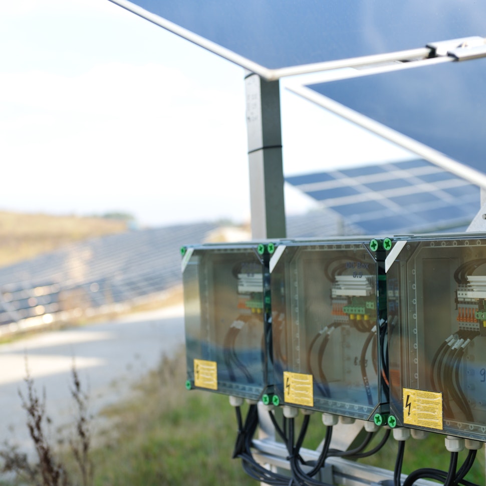 Combiner box on the end of a string of solar panels